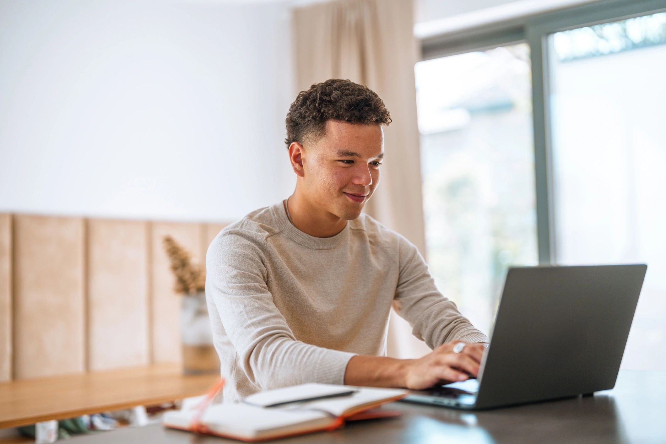 Person studying with a laptop at home