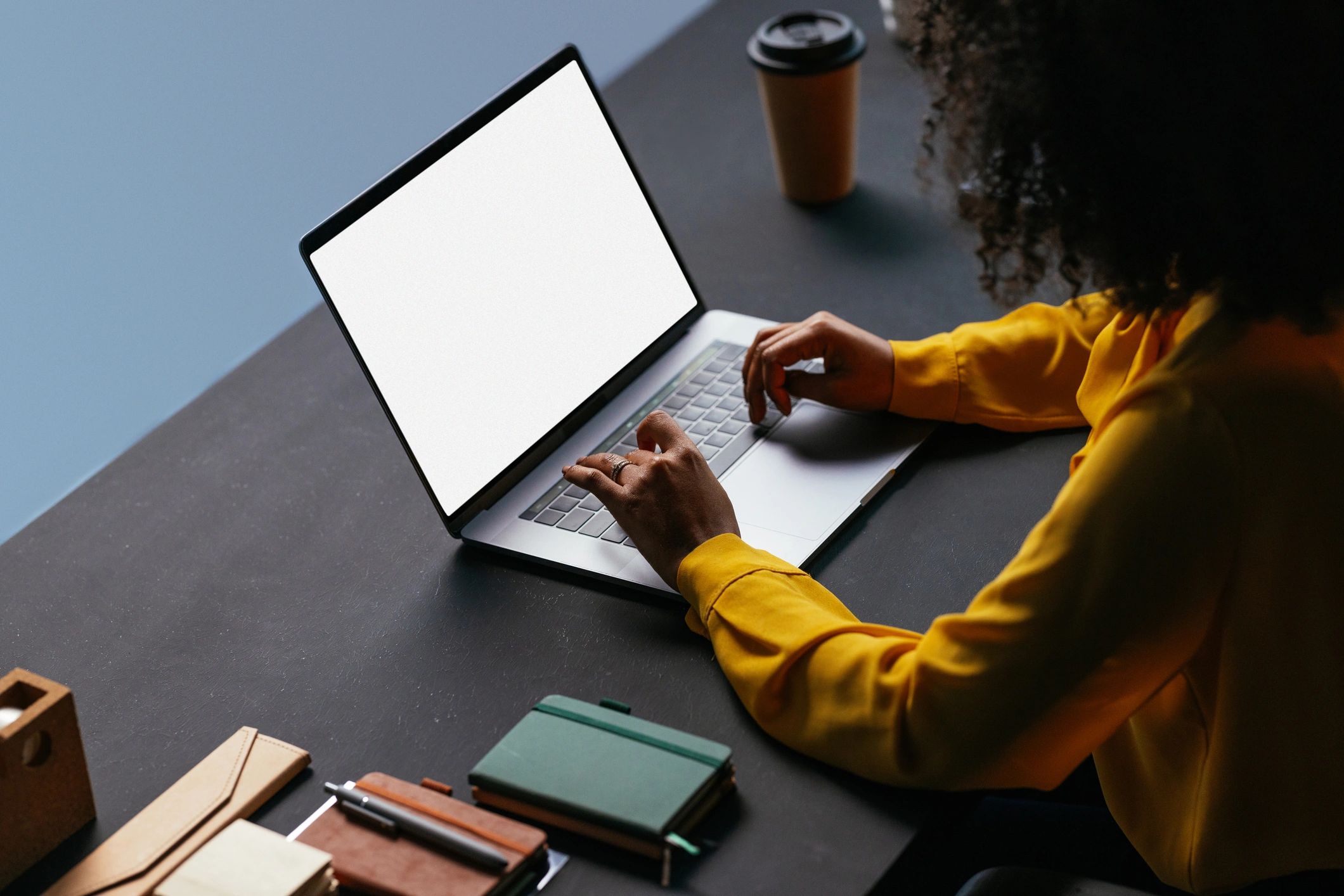 Person working on a laptop with planning materials