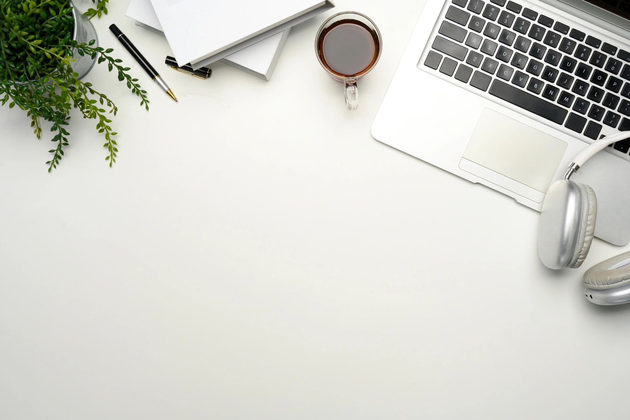 Minimalist workspace with laptop and notebooks, representing building systems