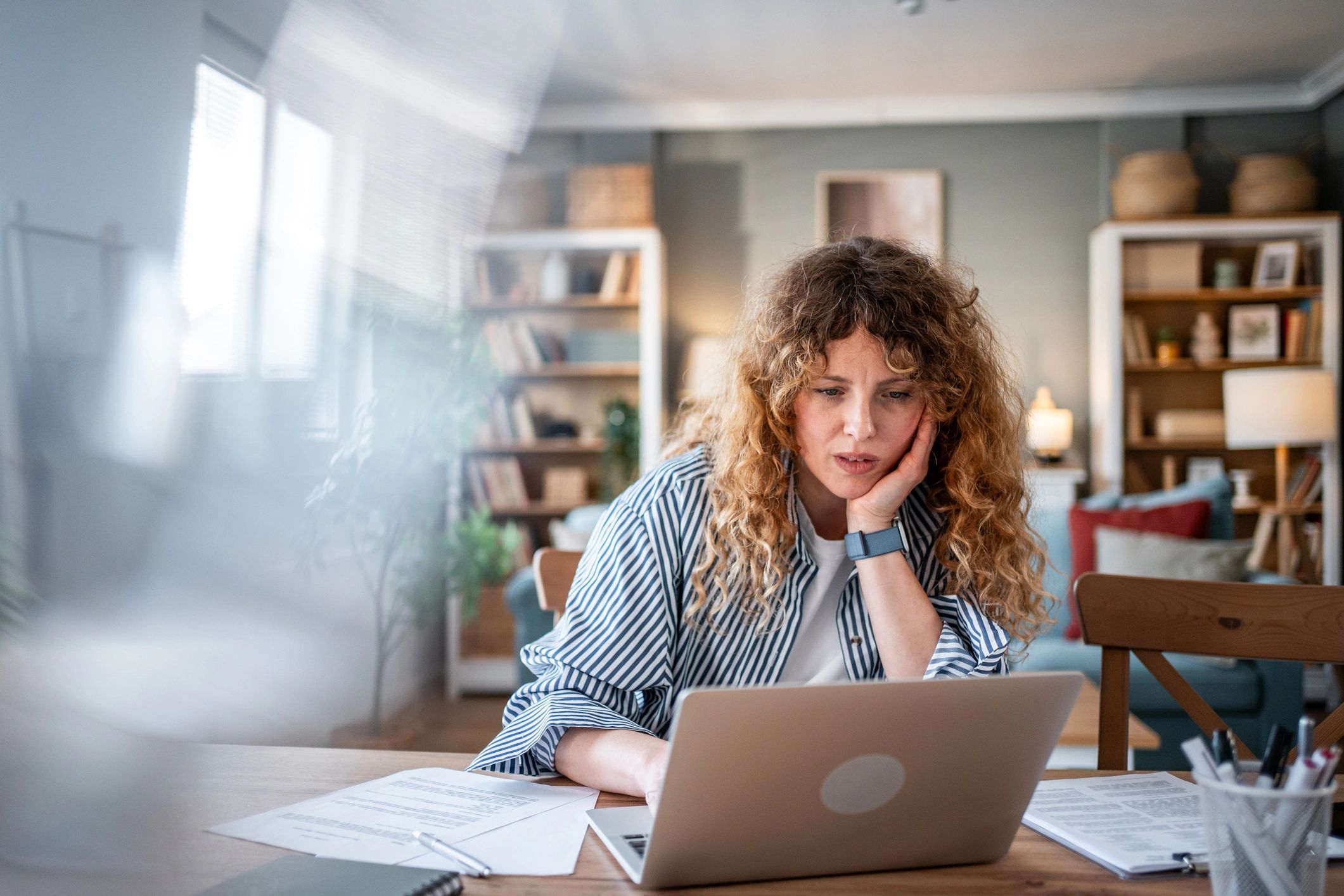 Woman working from home feeling stressed by deadlines