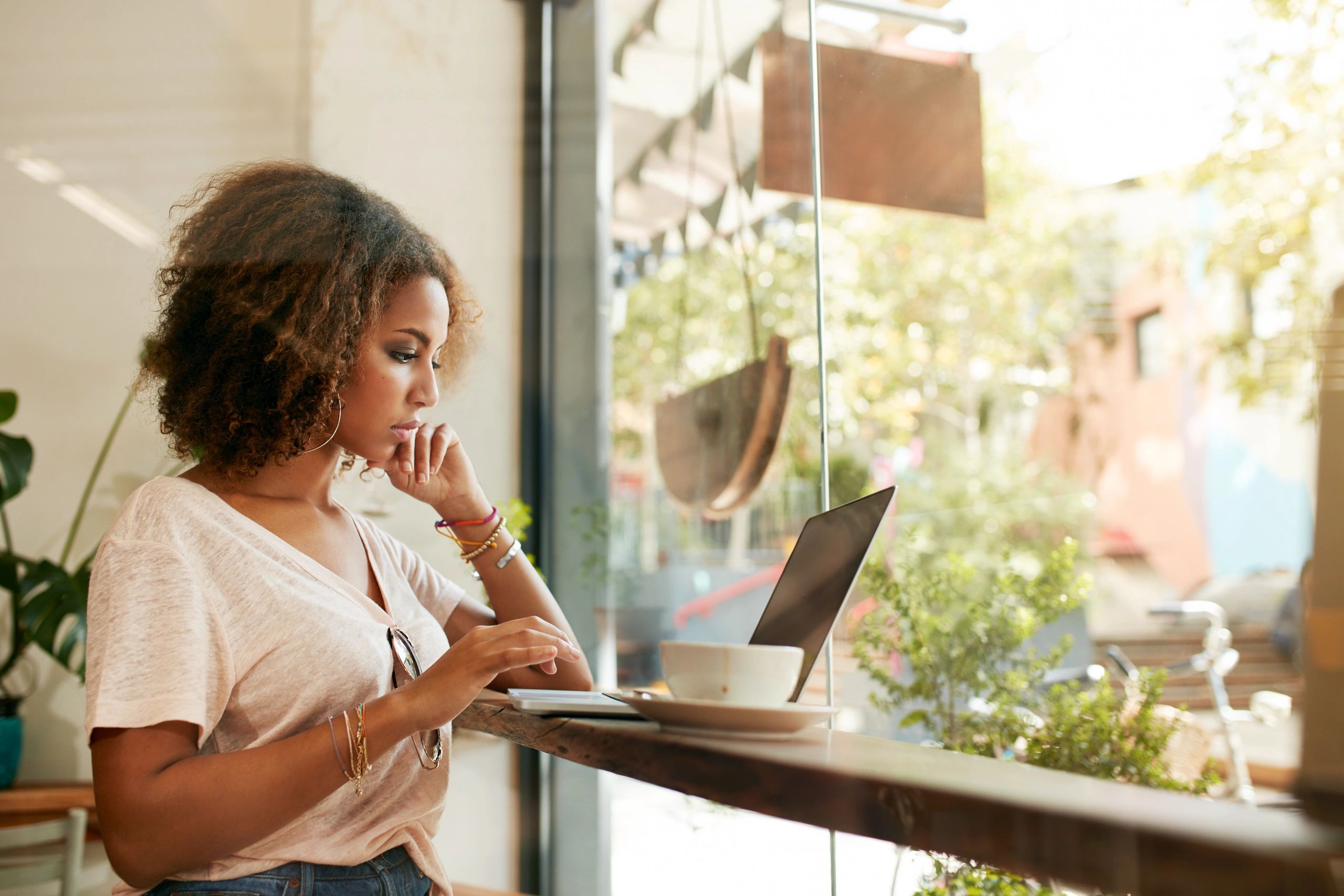 Woman working on a laptop in a cafe