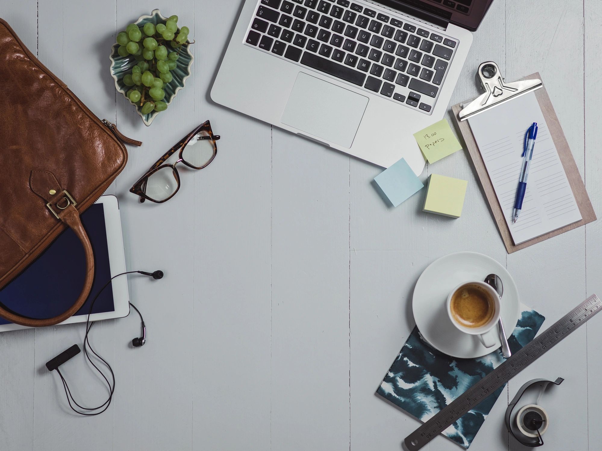 Overhead view of a desk with notebook and supplies